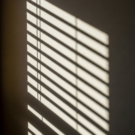 Shadow of window blinds on the wall in the morning. Sunlight.の素材
