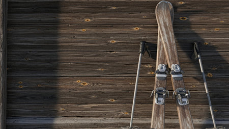 A wide angle, cinematic shot featuring a pair of classic wooden skis and crossed poles leaning againの素材