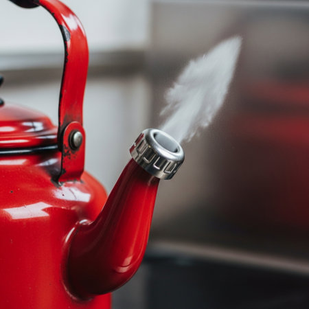 A focused, square-format (1:1) photograph capturing the critical moment of a vintage enamel kettle bの素材
