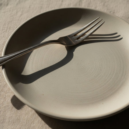 Hero detail shot focusing tightly on the texture of an empty, matte ceramic breakfast plate, emphasiの素材