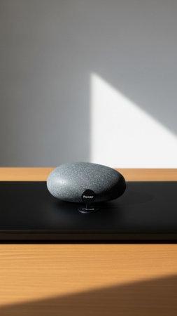A high-definition, vertical (9:16) image featuring a smooth, heavy river stone used as a paperweightの素材