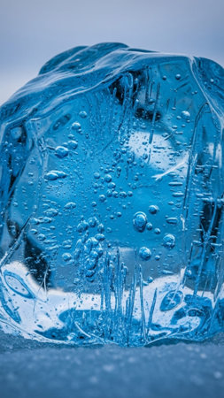 High-resolution vertical macro shot of ancient Icelandic glacial ice. Focus on deep blue texture, air bubbles, and fragmented light refraction.の素材