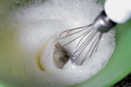 Whipping egg to make meringue.の写真素材