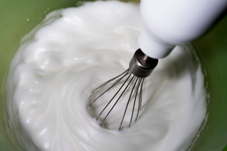 Whipping egg to make meringue.の写真素材