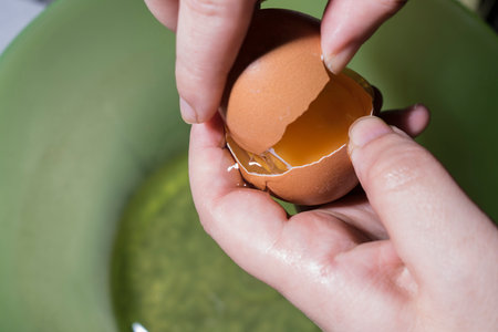 Separate yolks of white in the egg with your handsの写真素材