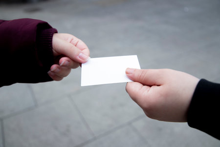 Close up of a child's hand holding a blank card.の写真素材