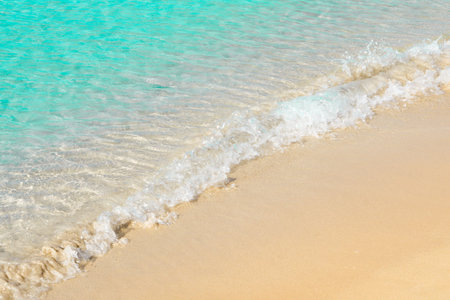 eashore with sea foam and sand, light blue summer beach, marine natural backgroundの写真素材