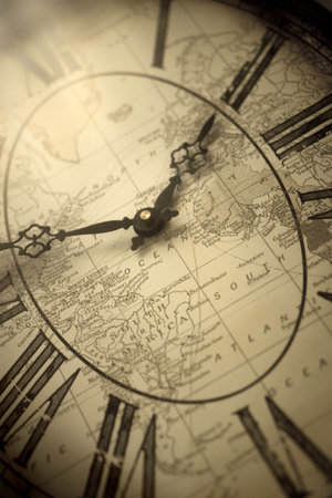 Shabby chic wall clock with a geographic map in the background, vintage retro moodの写真素材
