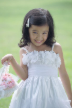 Angela posing for the camera in flower girl attireの写真素材
