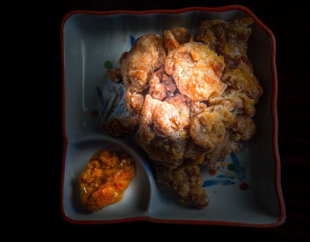 Crispy deep-fried pork in a plate on a wooden tableの写真素材