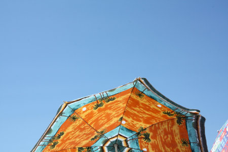 Background with orange umbrella on the beachの写真素材