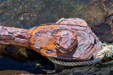 AALESUND, NORWAY - 2017 APRIL 27. A rusty boat mooring rings on stone quayside.のeditorial素材