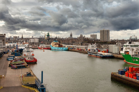 ABERDEEN, SCOTLAND - 2016 MARCH 21. Aberdeen Harbour with offshore vessels and dark clouds in the horizonのeditorial素材