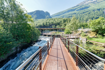 GEIRANGER, NORWAY - 2016 JUNE 14. Walking on the platform by the Storfossen waterfall at Geiranger heading to the Norwegian Fjord Centre (Norsk Fjordsenter) Museumのeditorial素材