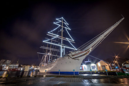 BERGEN, NORWAY - 2015 DECEMBER 23. Tall ship Statsraad Lehmkuhl with christmas lights on at Bergen...