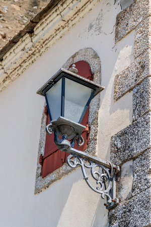 MOSTAR, BOSNIA HERZEGOVINA - 2017 AUGUST 16. Street lamp and a window with iron shutters in the Old Bazaar Kujundziluk, the muslim quarter of the old town of Mostar.のeditorial素材