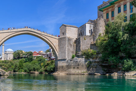 MOSTAR, BOSNIA HERZEGOVINA - 2017 AUGUST 16. Old Arc bridge in Mostar, Bosnia and Herzegovina. Destroyed during the war. It was then rebuild after the war. Beautiful cityscape of Mostar.のeditorial素材