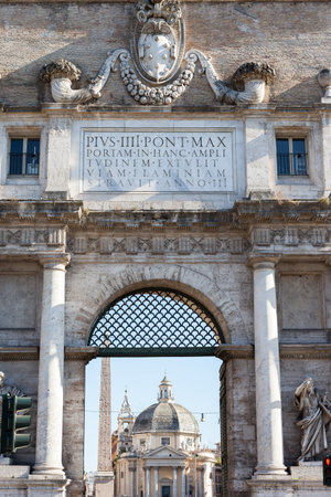 ROME, ITALY - 2014 AUGUST 17. Santa Maria dei Miracoli and Santa Maria in Montesanto are two sister churches in Rome. Seen true the gate of the Aurelian Wall.のeditorial素材