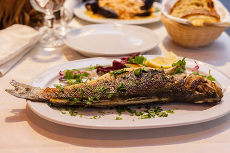ROME, ITALY - 2014 AUGUST 18. Fried whole fish on a dish in Rome.