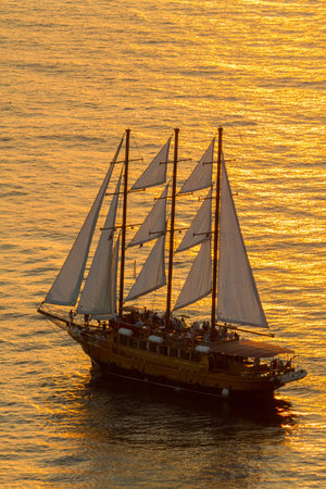 SANTORINI, GREECE - 2013 august. Sailboat Close Up In The Sunset At Santorini.
