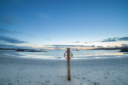 AKRAHAMN, NORWAY - 2016 FEBRUARY 26. Akrahamn beach with beautiful sunset and blue sky.のeditorial素材