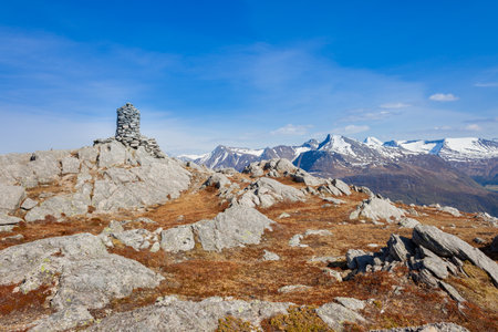 Cairn (a pile of stones) marking mountain hiking trail in Norwayの写真素材