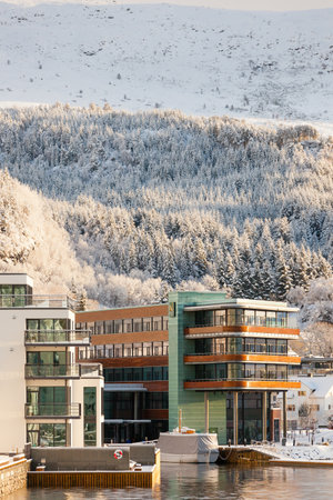 ULSTEINVIK, NORWAY 2016 JANUARY 31. Quality Hotel Ulstein and apartments in Ulsteinvik city with snow in the background.のeditorial素材