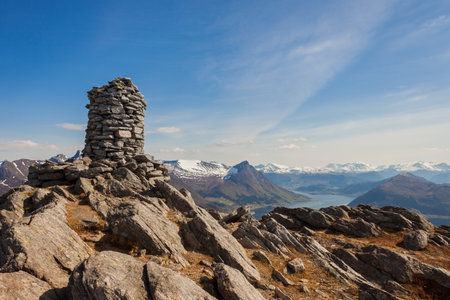 ULSTEINVIK, NORWAY - 2014 APRIL 27. Cairn (a pile of stones) marking mountain hiking trail in Norway.のeditorial素材