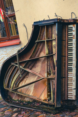 VILNIUS, LITHUANIA - 2020 MARCH 07. Abandoned gran piano, rundown piano by a river bank Vilnia river in Uzupis artists quarter in Vilnius.のeditorial素材