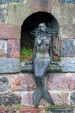 VILNIUS, LITHUANIA - 2020 MARCH 07. Iconic sculpture of Mermaid by Romas Vilciauskas on the embankment of Vilnele river in Uzupis district of Vilnius.のeditorial素材