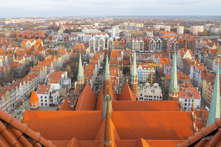 GDANSK, POLAND - 2020 JANUARY 19.City viewed from the top of a cathedral tower with red roof and green metal banner in the foregroundのeditorial素材