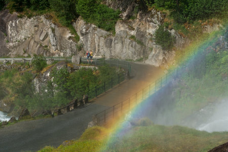 LOEN, NORWAY - 2020 JUNE 20. Rainbow at the bridge to Briksdalsbreen Glacier in Norway.の写真素材