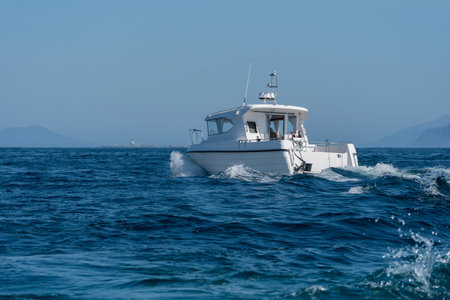 RUNDE, NORWAY - 2020 JUNE 19. White boat sailing out for sport fishing.のeditorial素材