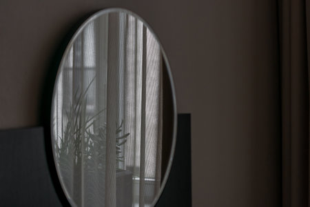 VILNIUS, LITHUANIA - 2020 MARCH 05. Big round mirror in living room modern interior, retro luxury oval mirror new design.の写真素材