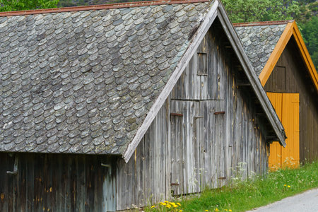 TAFJORD, NORWAY - 2020 JUNE 01. Rustic old slate roof on a boat house.