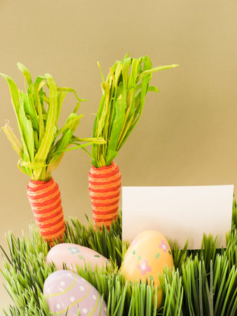 Easter eggs and carrots in the grass.