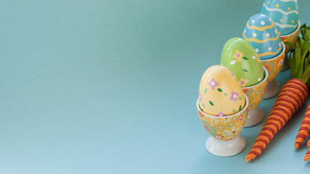 Painted easter eggs and decorative carrots.の写真素材