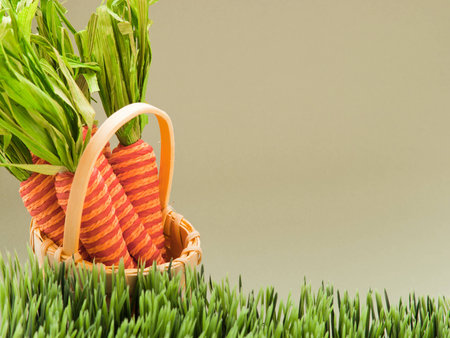Easter carrots in yellow basket.の写真素材