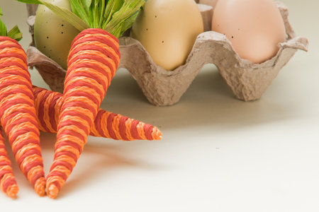 Spring carrots and painted easter eggs.の写真素材