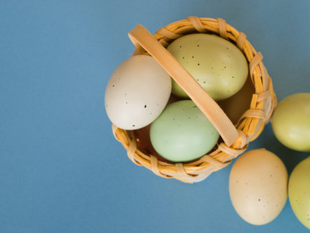 Easter eggs in yellow basket.の写真素材