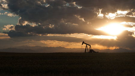A pumpjack silhoutte with dramatic sunset.の写真素材