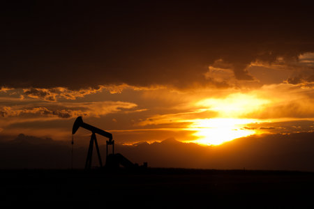 A pumpjack silhoutte with dramatic sunset.の写真素材