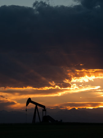 A pumpjack silhoutte with dramatic sunset.の写真素材
