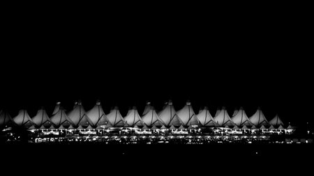 Denver International Airport at night against dark sky.のeditorial素材