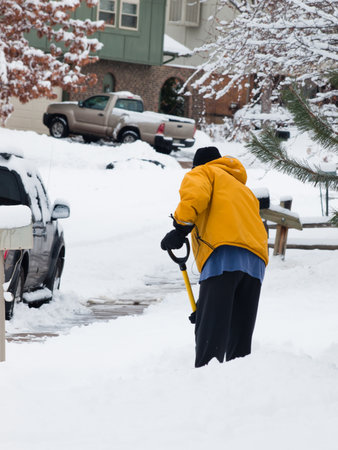 A man shoceling his sidewalk.のeditorial素材