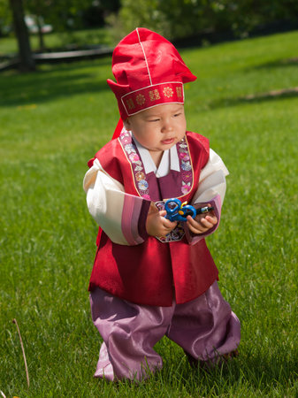 Asian baby, one year old child wearing the traditional Korean cultural ethnic attire, called "han-bok".の写真素材