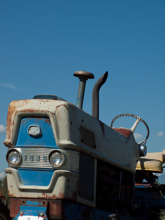 Men harvesting hay with old farm equipment.のeditorial素材