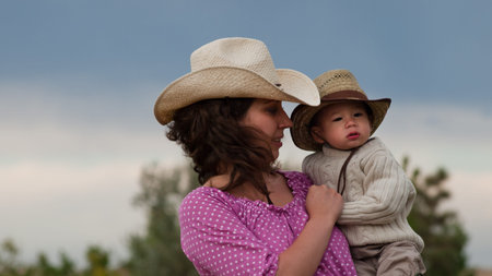 Toddler boy with his mom on the farm.