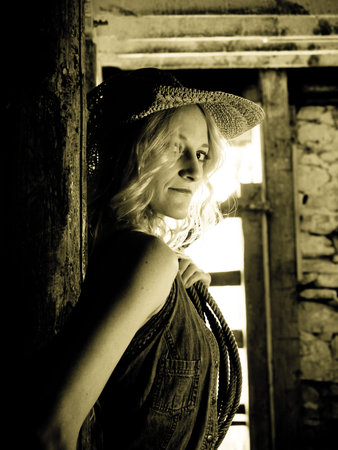 Country girl inside of an old barn.の写真素材