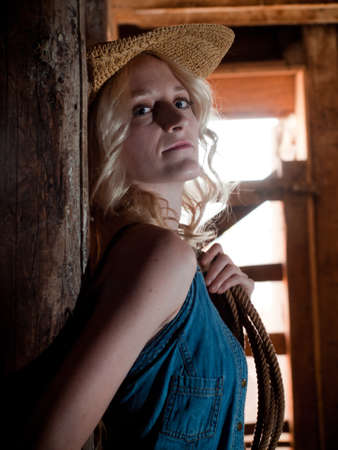 Country girl inside of an old barn.の写真素材